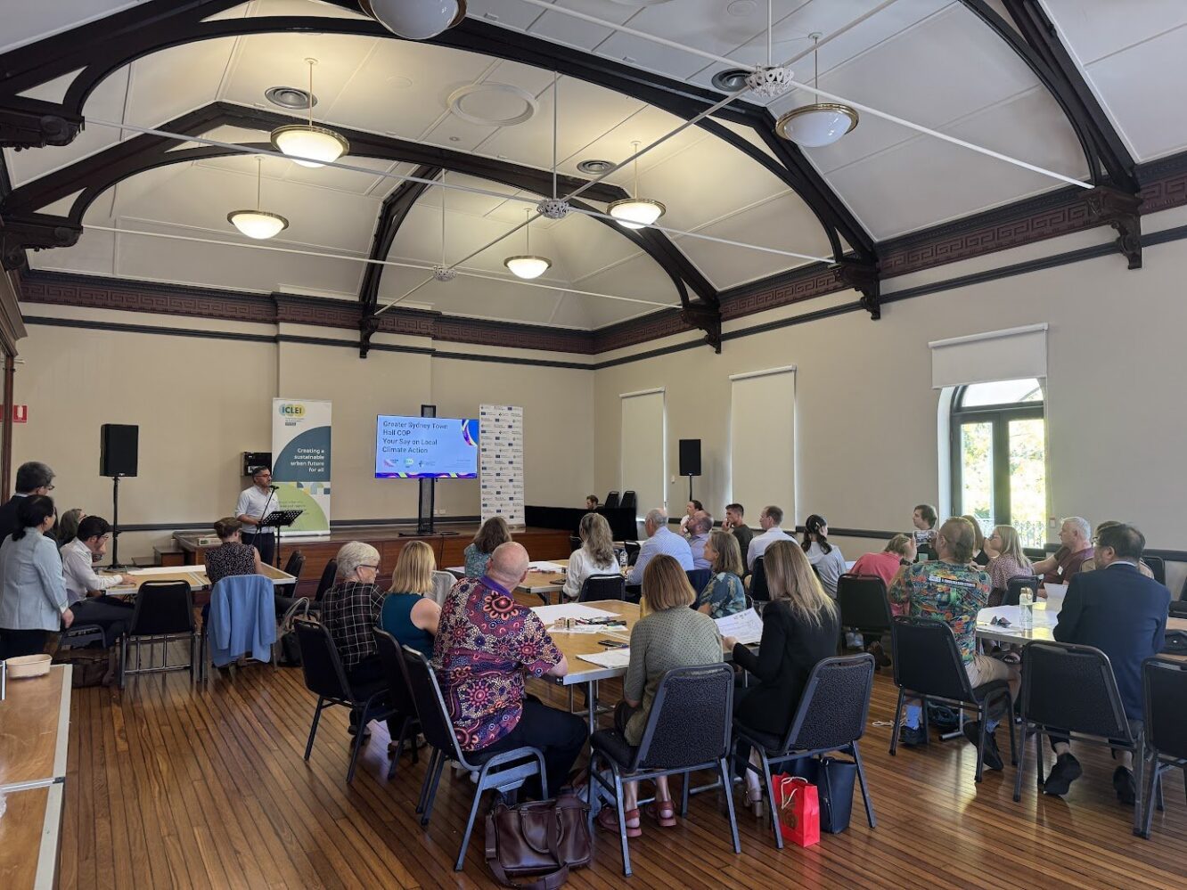 Attendees facing the podium at the Sydney Town Hall COP